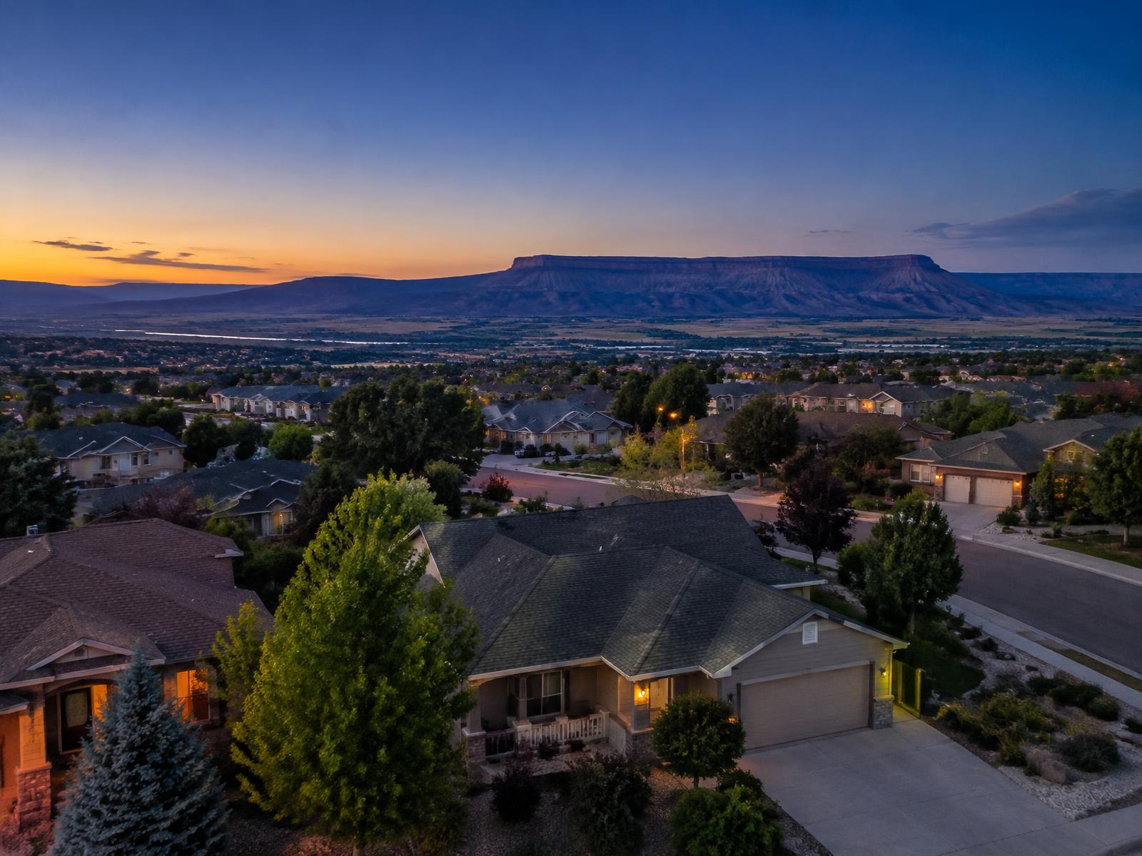 Grand Junction neighbourhood rooftops at dusk with the Grand Mesa on the horizon